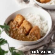 A bowl of vibrant vegan katsu curry, perfectly plated with crisp jackfruit katsu, rich curry, and rice, ready to be enjoyed.