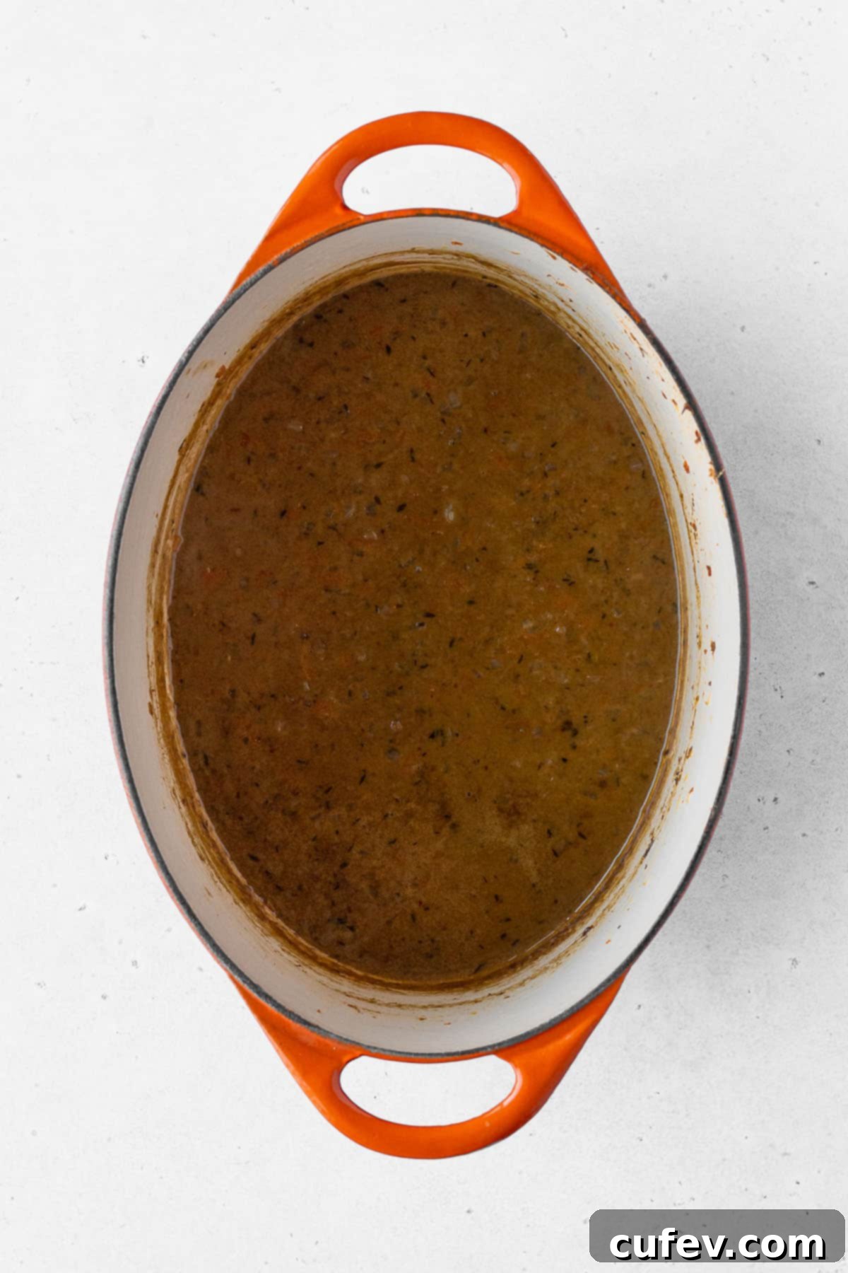 The finished vegan Japanese curry simmering in an orange-handled pot, boasting a rich, inviting color and creamy texture.