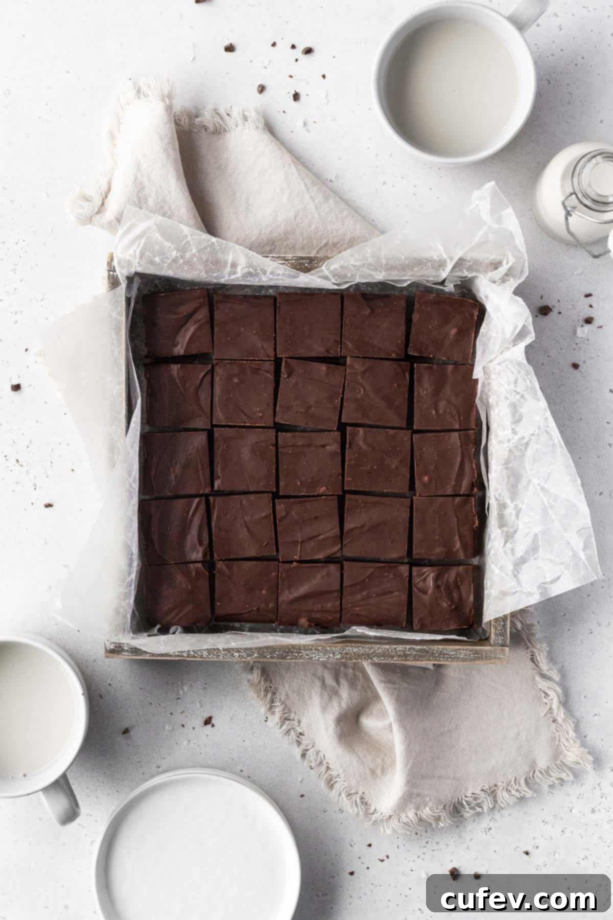 Overhead shot of square baking tin with a batch of dairy-free fudge cut into 20 squares.