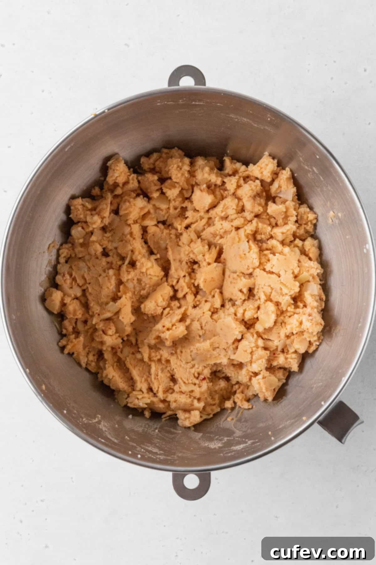 Vegan potato croquette mixture is pale orange and thick.