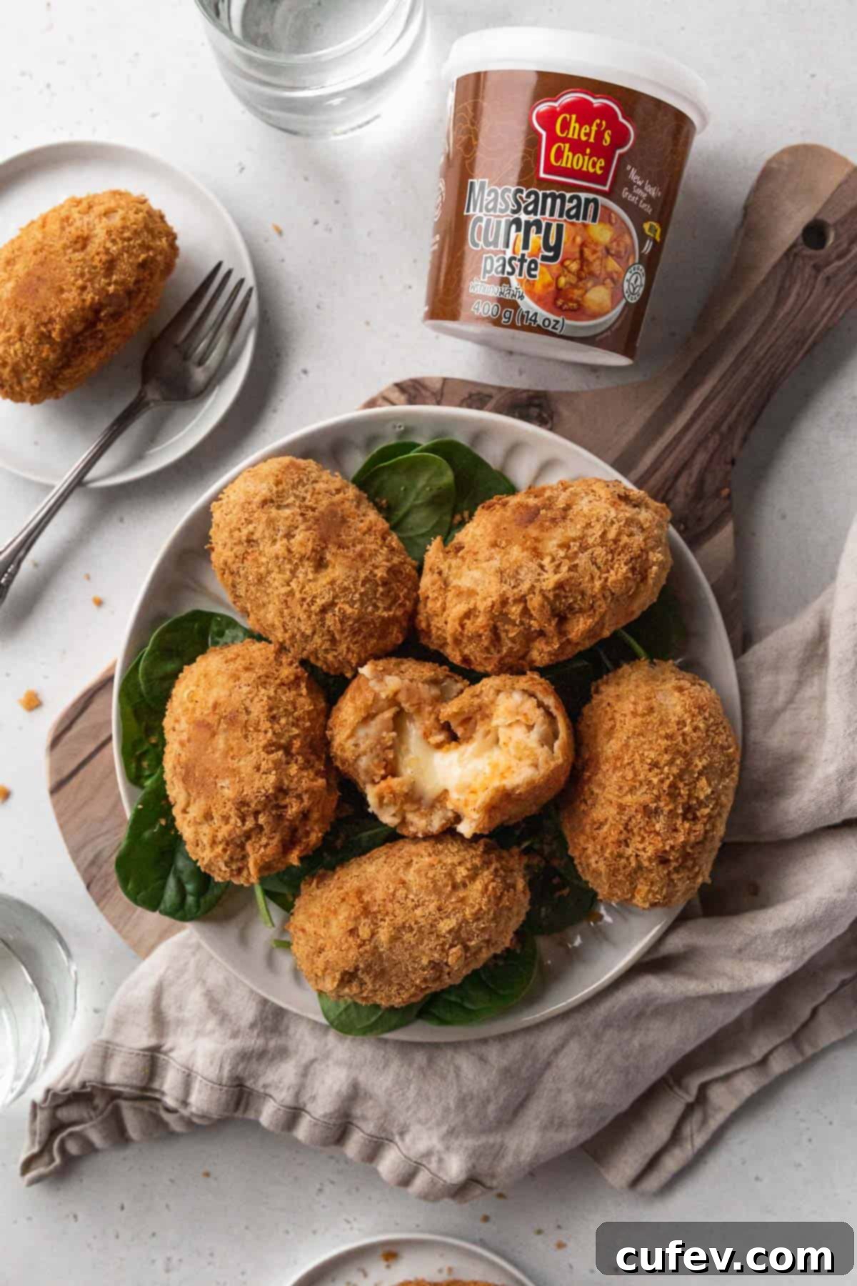 Overhead branded hero shot of vegan potato croquettes with a jar of chef's choice massaman curry paste.