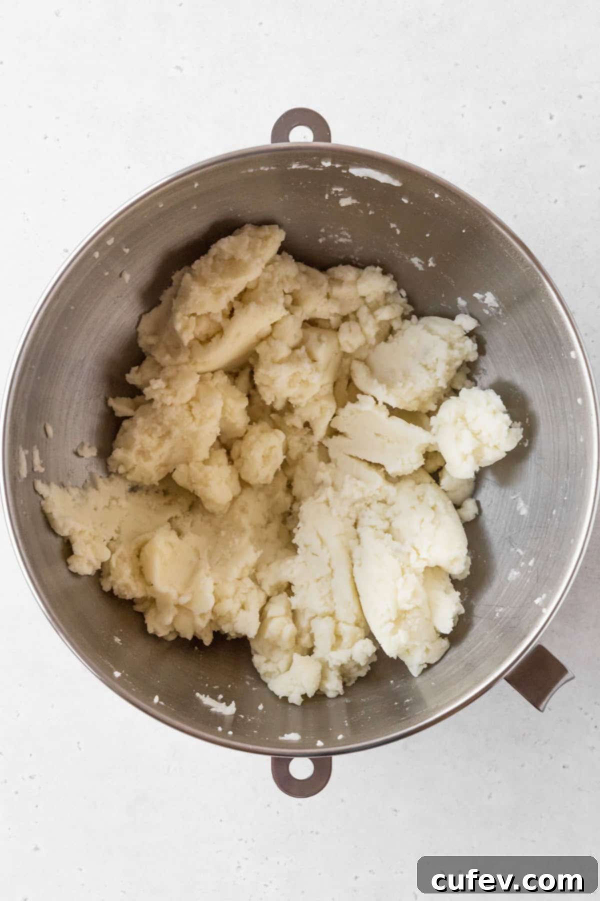 Potato mash mixture is thick and looks slightly crumbly.
