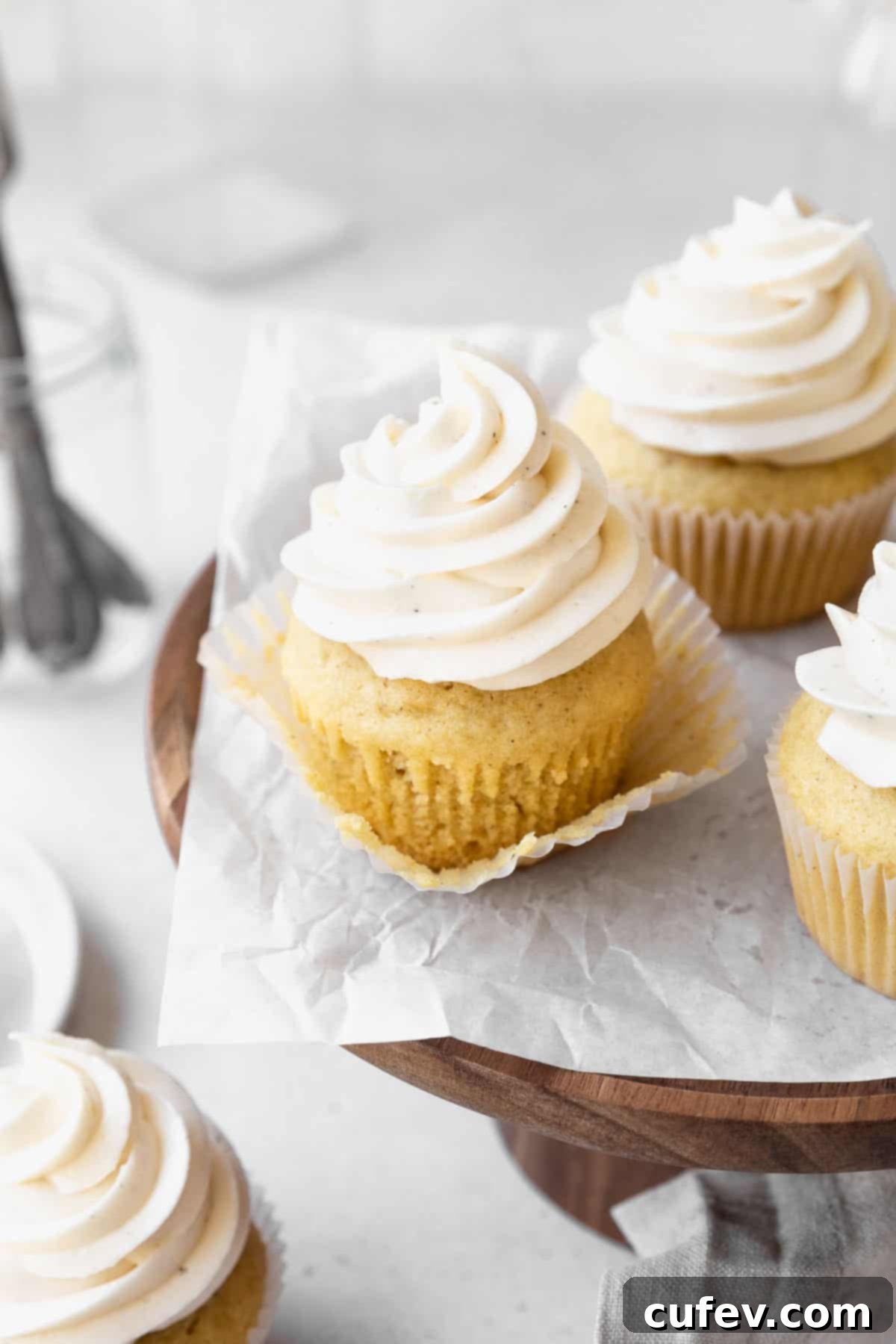 Guilt-Free Cupcakes 10 A dairy-free vanilla cupcake with its paper wrapper peeled away, revealing a beautifully light, airy, and tender texture of the cake itself.