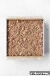 Crumble topping added to the top of the coffee cake batter, forming a generous, even layer.