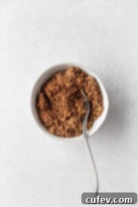 Cinnamon sugar coffee cake filling in a small white bowl, showing a fine, uniform mixture.