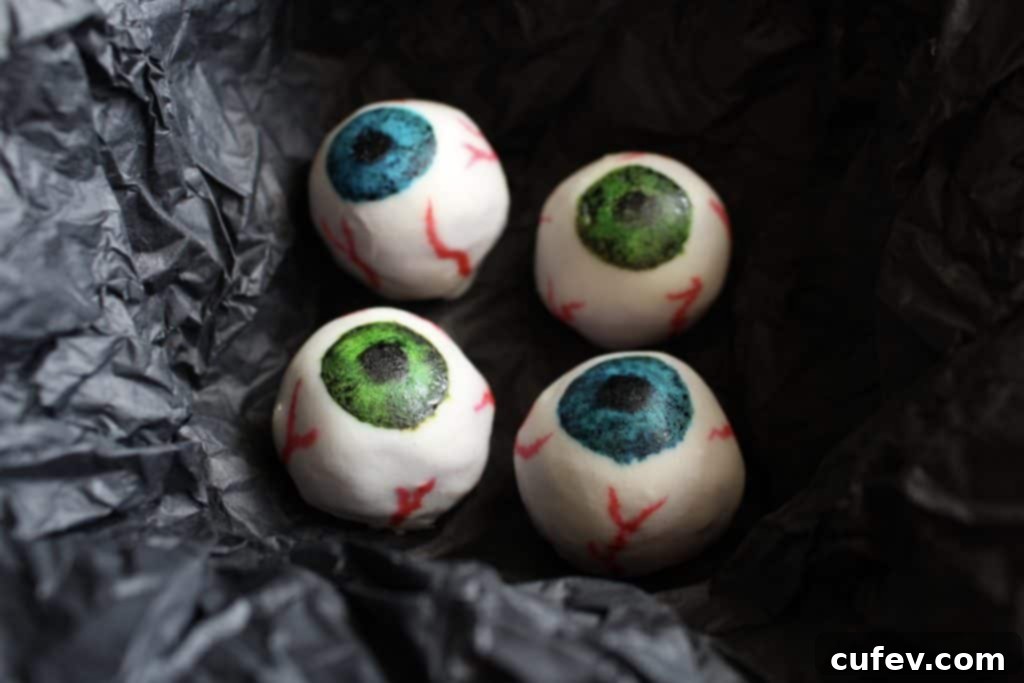 Vibrant Halloween white chocolate eyeballs with a healthy purple sweet potato filling, perfect for trick-or-treaters