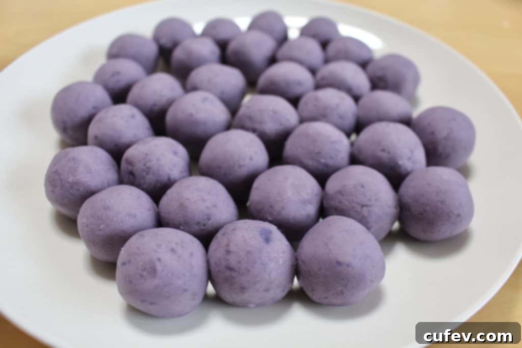 Perfectly rolled purple sweet potato balls, ready for their white chocolate coating for spooky Halloween eyeballs