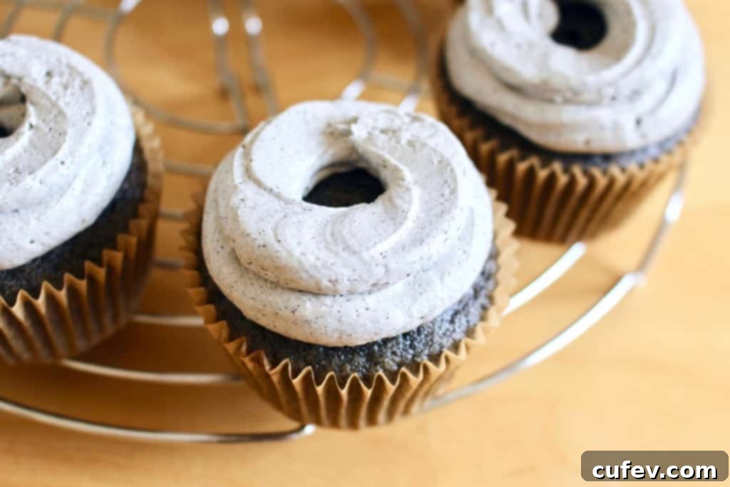 Black sesame cupcakes generously topped with piped black sesame buttercream frosting.