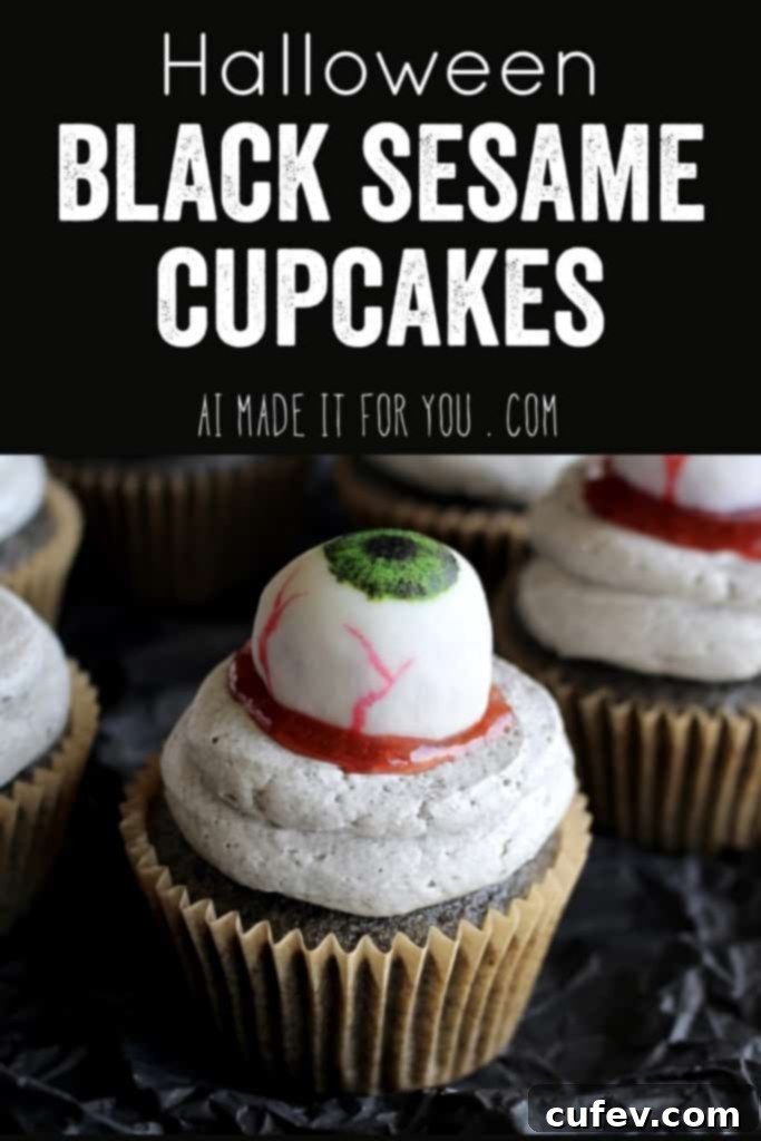 A close-up shot of an individual Halloween black sesame eyeball cupcake, highlighting the white chocolate eyeball and the dark cupcake base.