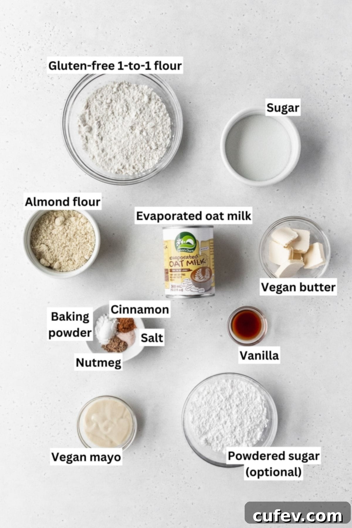 Ingredients needed for making dairy free gluten free vegan baked donuts laid out on a white table with text overlay.