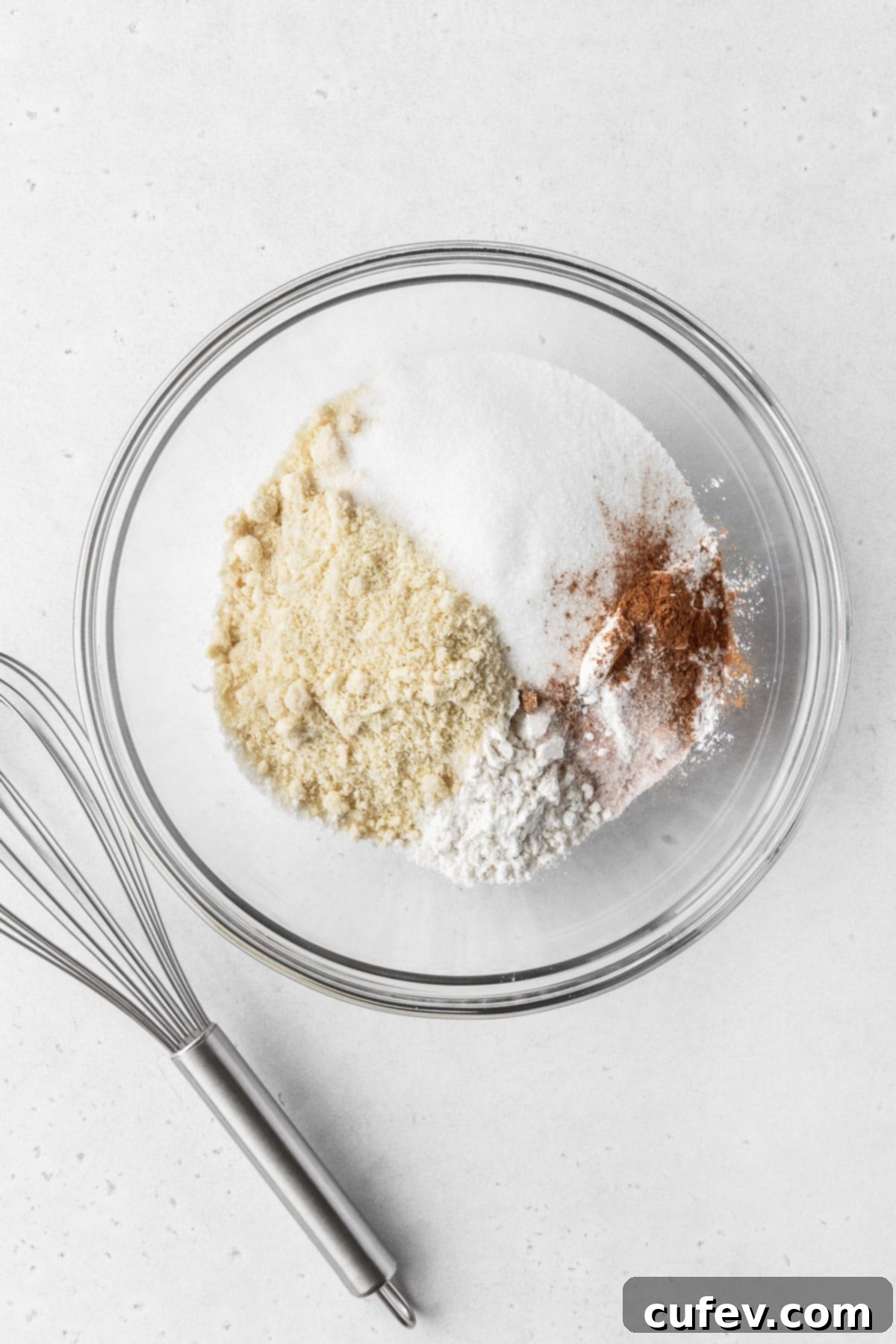 Dry ingredients for making dairy free gluten free vegan baked donuts in a mixing bowl.