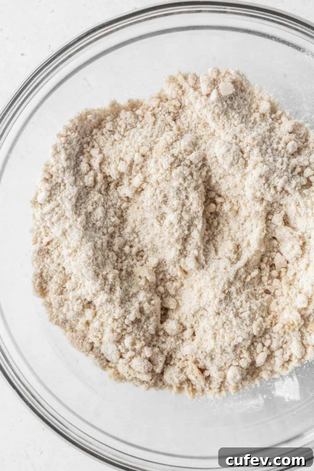 Close-up on dry ingredients after whisking with vegan butter.