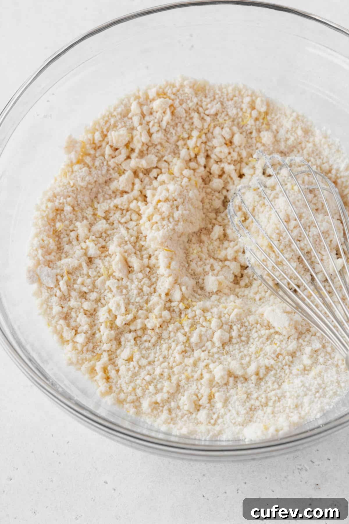 The mixture looks like wet sand after whisking in the butter.