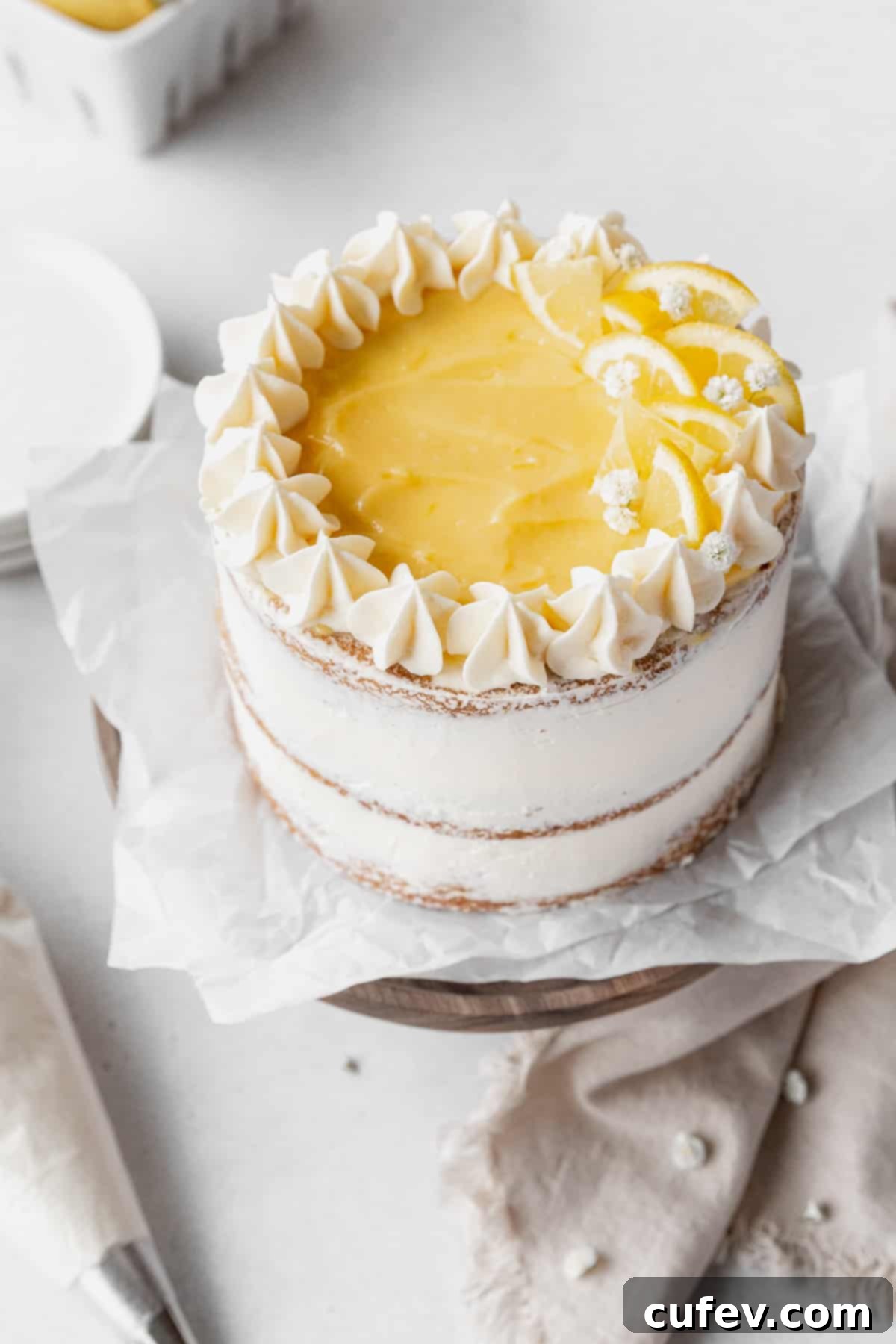 45 degree angle shot showing the top of the decorated dairy-free lemon curd cake.