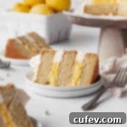 Square hero shot of a slice of dairy-free lemon curd cake on a white dessert plate.