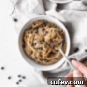 Square hero shot of vegan dairy-free edible cookie dough in a bowl with a hand taking a spoonful.