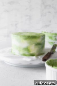 Matcha cake on a cake stand.