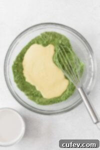 Wet ingredients being added to the dry matcha flour mixture.