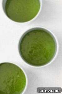 Matcha cake batter in three cake pans.