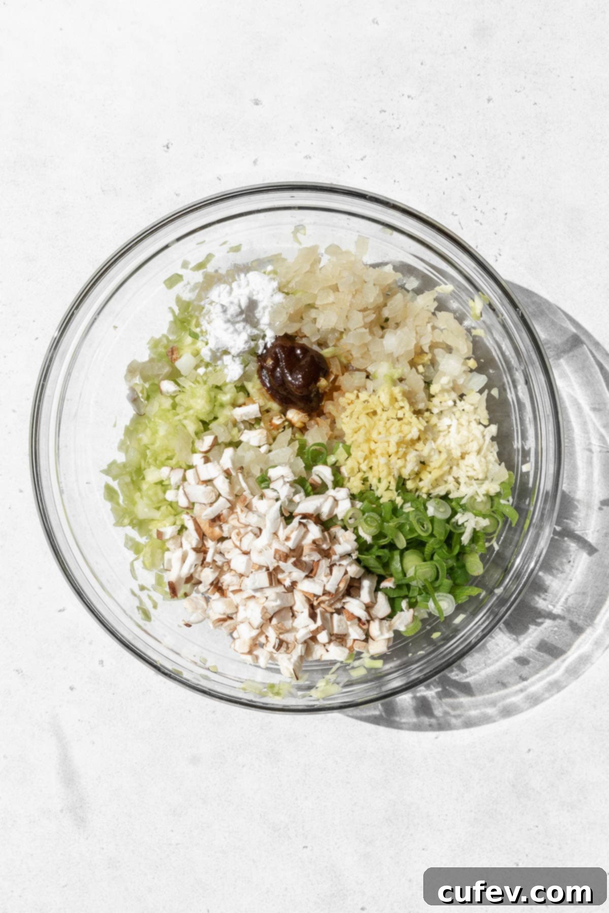 Various vegan dumpling filling ingredients measured out into bowls, prior to mixing.