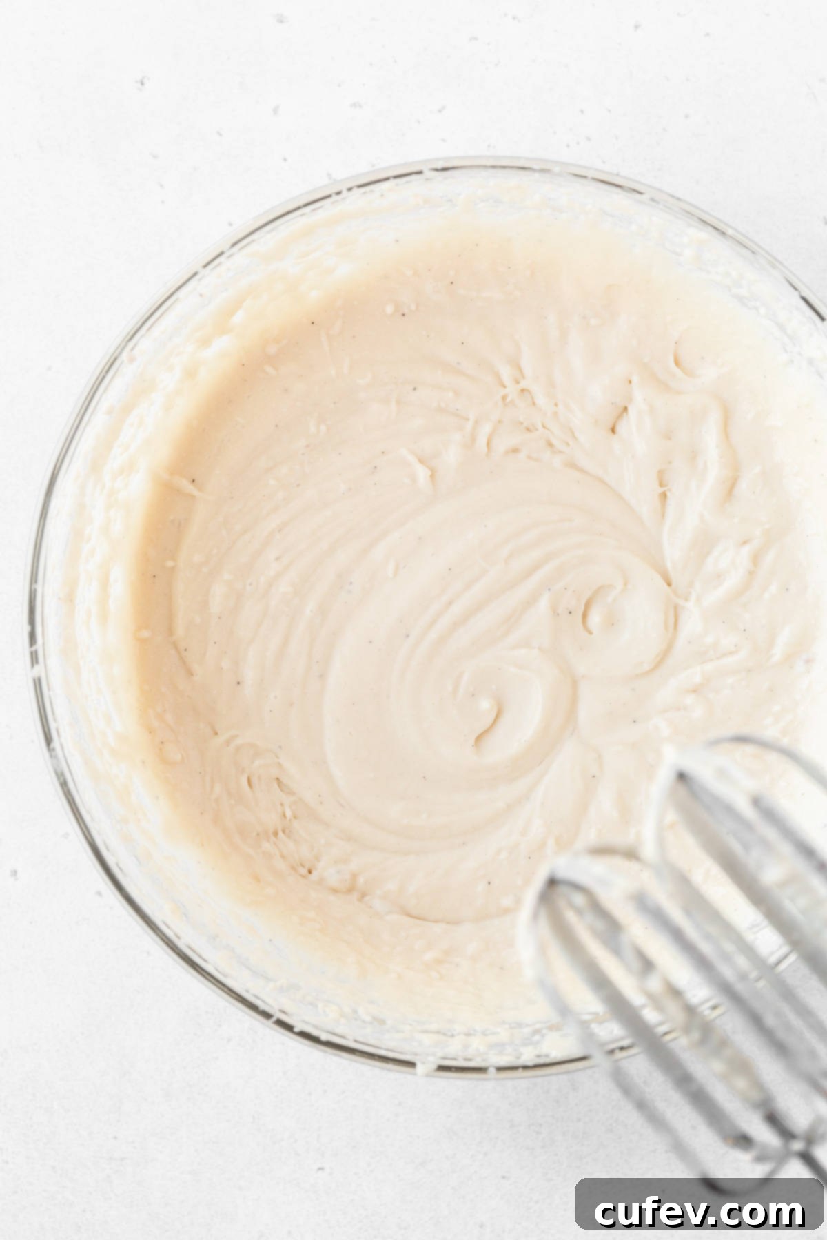 The smooth and creamy dairy-free ice cream base, perfectly prepared and resting in a glass mixing bowl, before its final freeze.