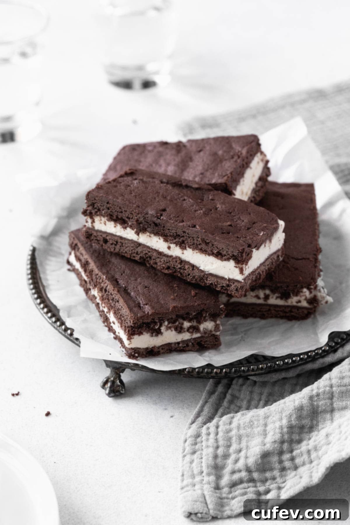 A beautifully arranged stack of gluten-free ice cream sandwich cookies on an elegant antique serving platter, highlighting their perfect texture and presentation.