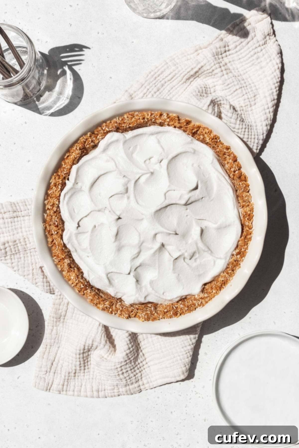 Whipped coconut cream swooshed on top of the vegan coconut custard in the gluten-free pie shell.
