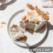 Square hero image of vegan no bake coconut cream pie on a white plate with a fork taking a bite out.