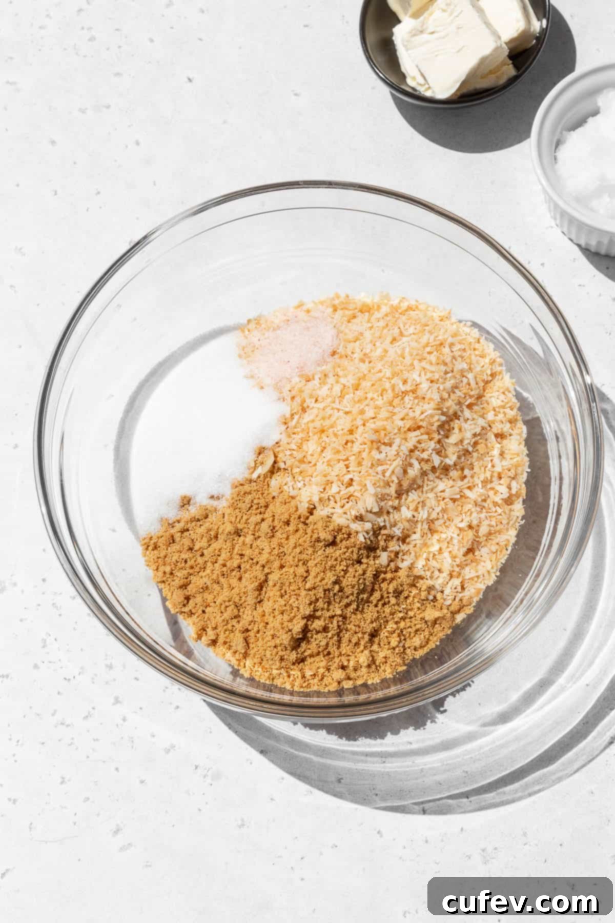 Dry ingredients for making gluten-free coconut graham cracker pie crust in a mixing bowl.