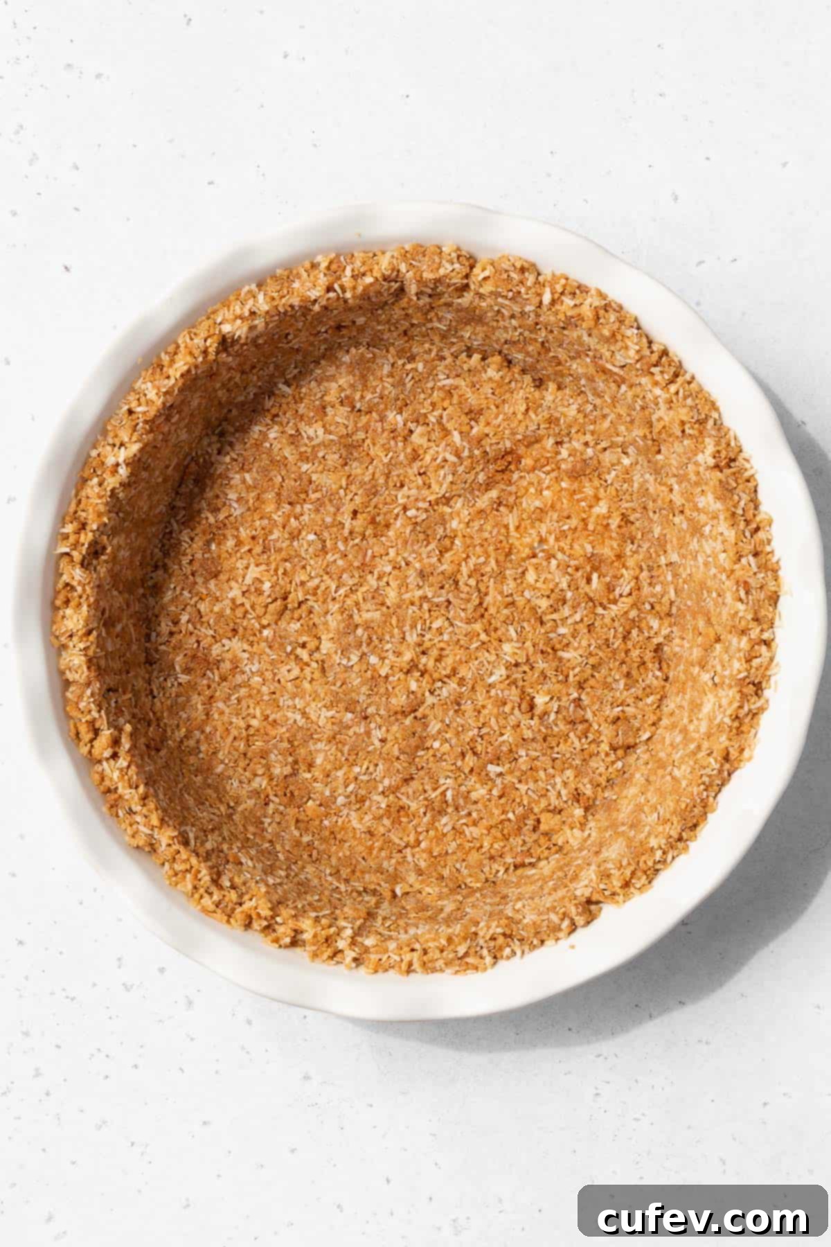 Gluten-free coconut pie crust after pressing into the pie pan.