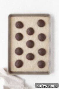 Gluten Free Whoopie Pies 9 Baked whoopie pie cakes on a parchment paper lined baking sheet.