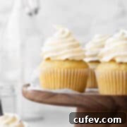 Square hero image of vegan vanilla cupcakes topped with a swirl of dairy-free vanilla buttercream.