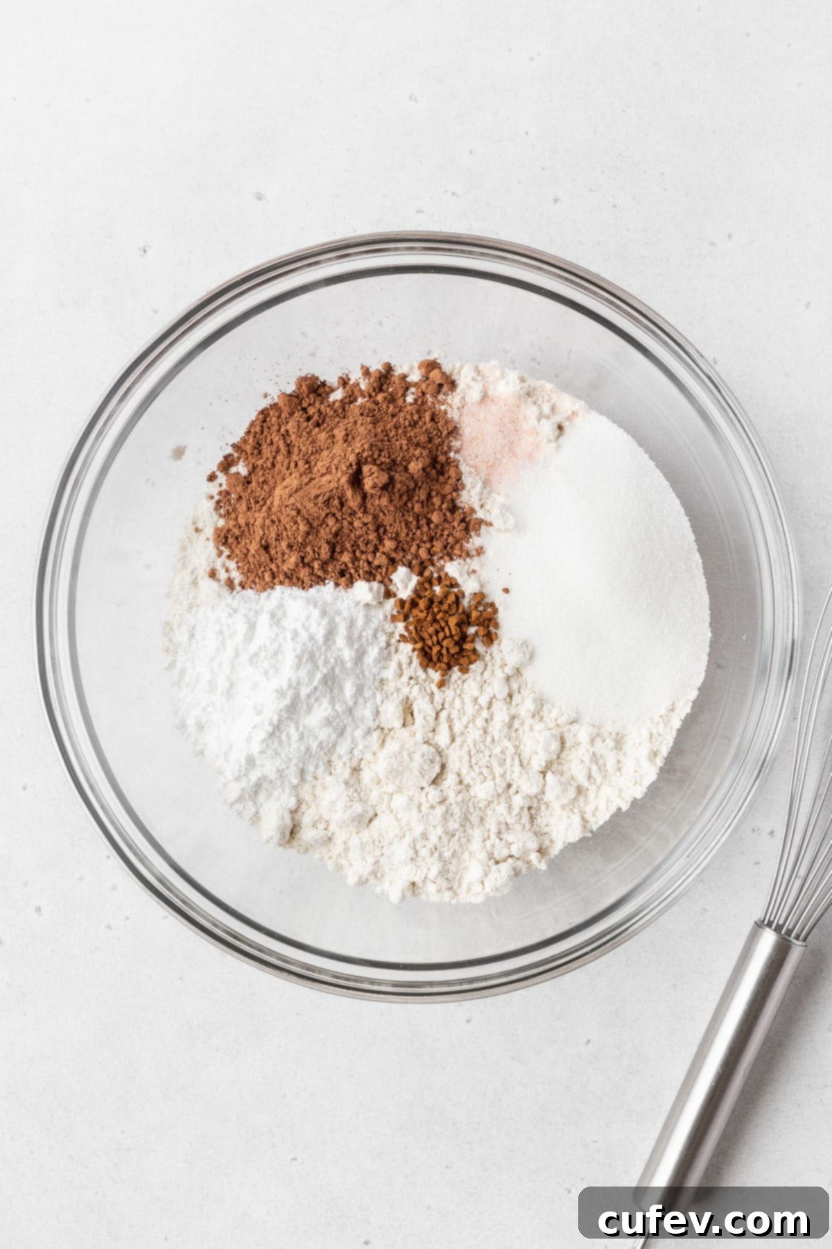 A glass mixing bowl of all of the dry ingredients.