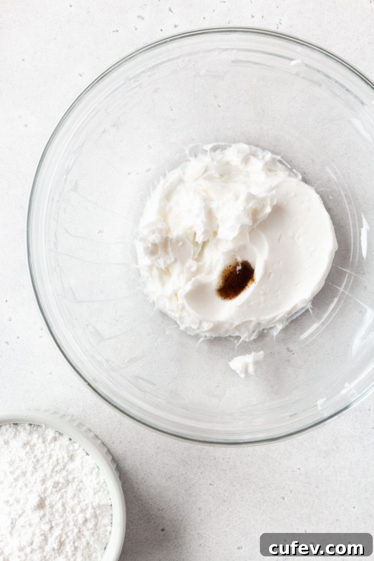 All of the cream cheese glaze ingredients in a glass mixing bowl.