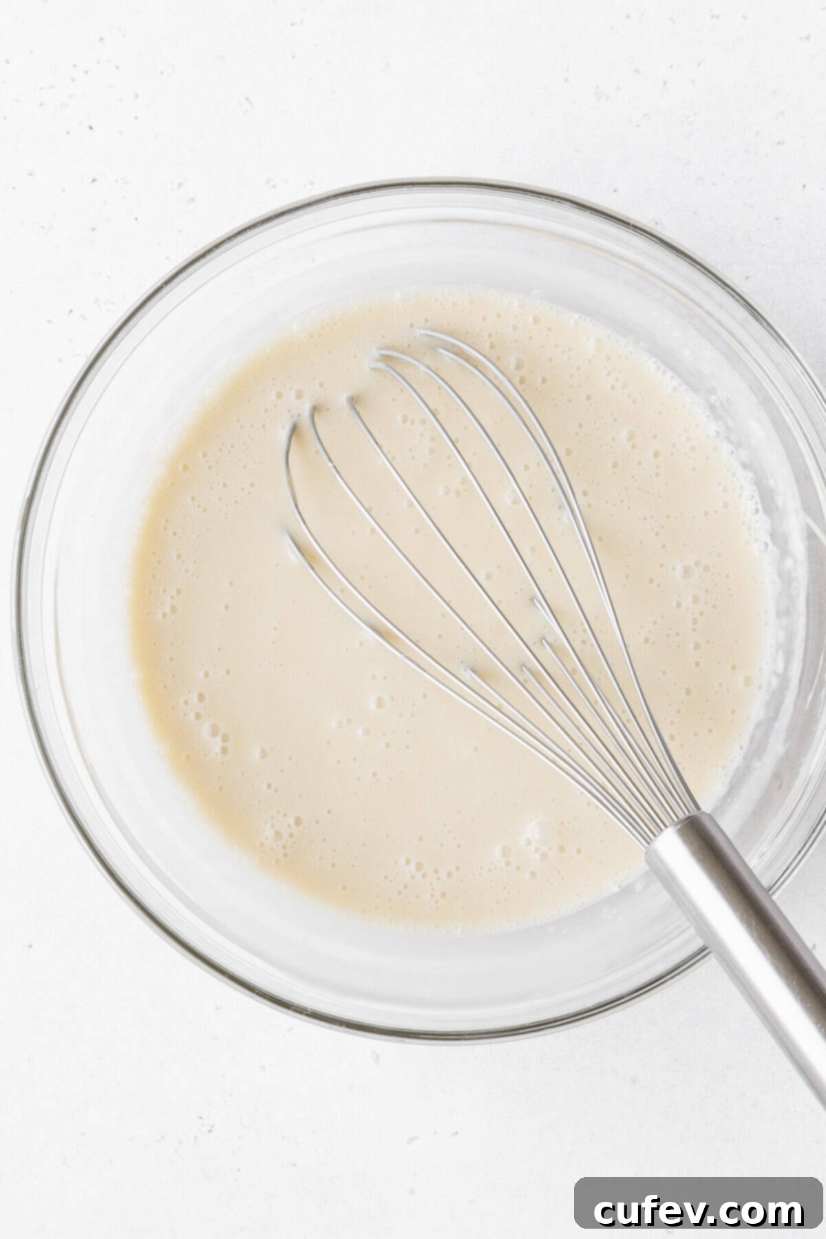 Indulgent Gluten-Free and Dairy-Free Tres Leches Cake 11 The gluten-free and dairy-free tres leches milk soak mixed together in a glass mixing bowl.