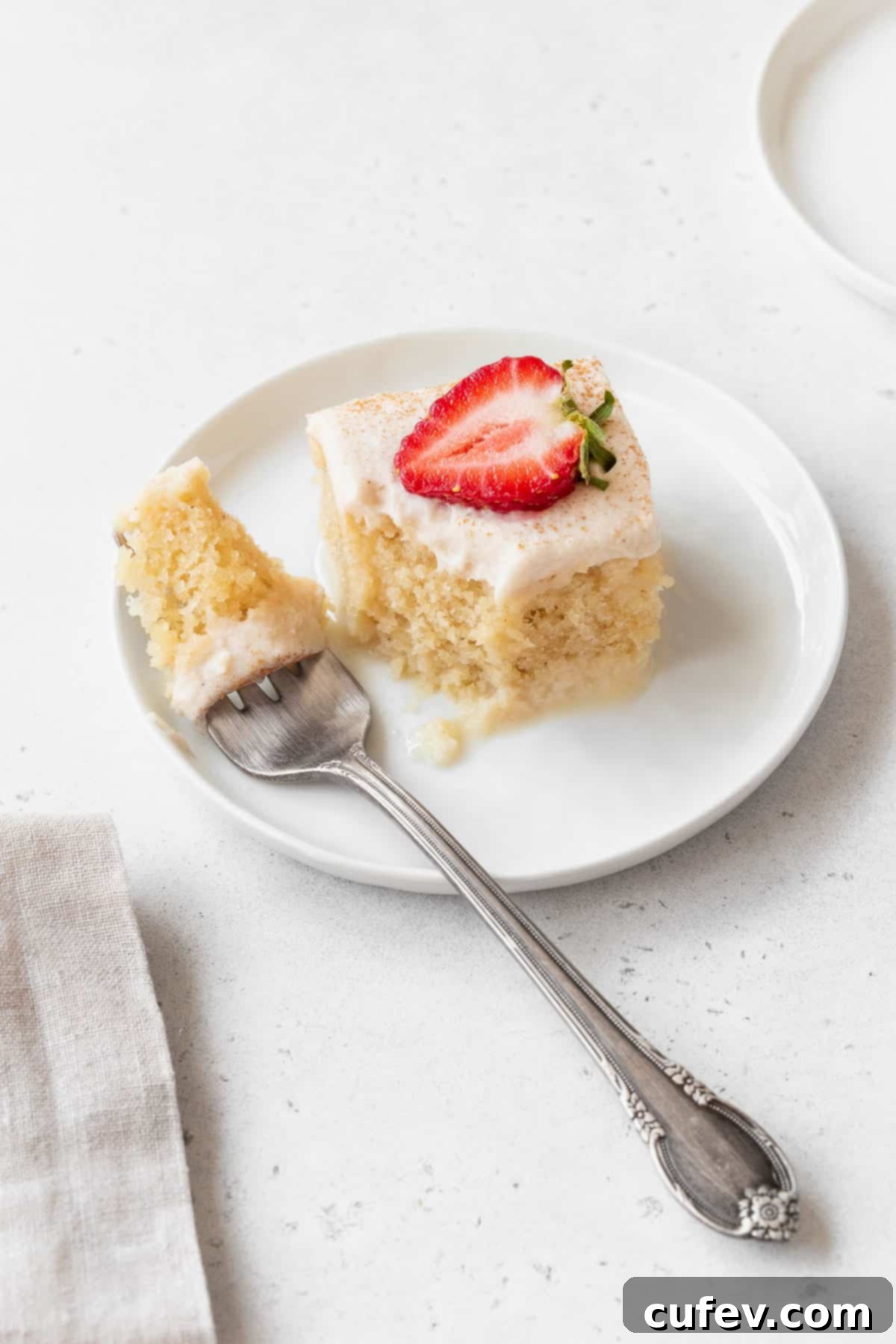 Indulgent Gluten-Free and Dairy-Free Tres Leches Cake 16 Taking a bite out of a piece of the gluten-free and dairy-free tres leches cake.
