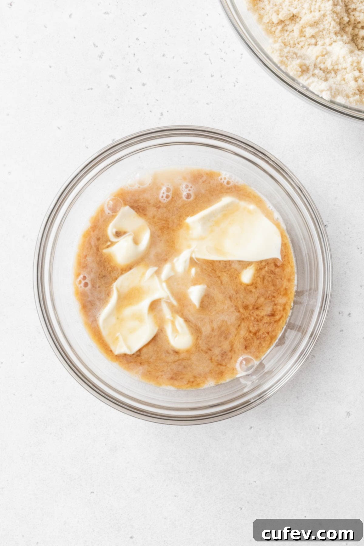 Indulgent Gluten-Free and Dairy-Free Tres Leches Cake 7 A glass mixing bowl of milk, vanilla, and mayonnaise.