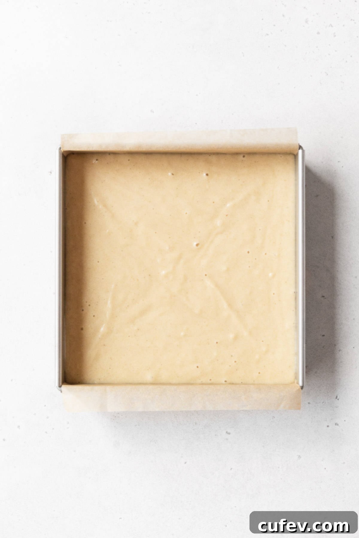 Indulgent Gluten-Free and Dairy-Free Tres Leches Cake 9 An 8x8-inch baking pan of the gluten-free and dairy-free tres leches cake before baking.