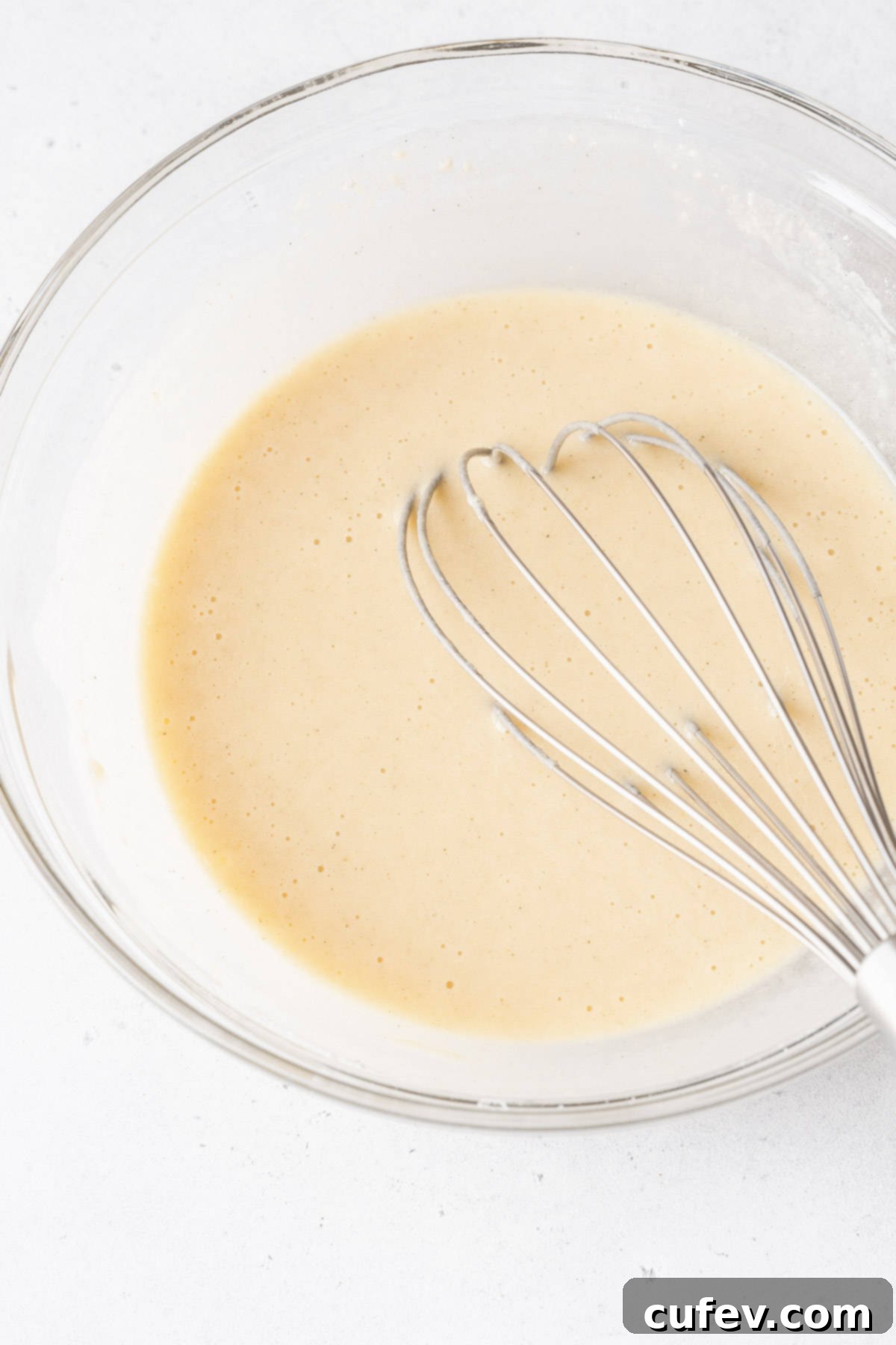 Smooth and creamy muffin mix pancake batter in a bowl after being whisked together.