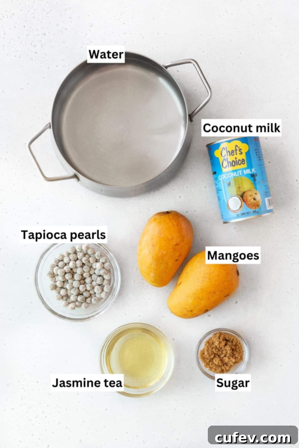 Tropical Mango Bubble Tea 3 All of the fresh ingredients for mango boba tea laid out neatly on a white kitchen counter.
