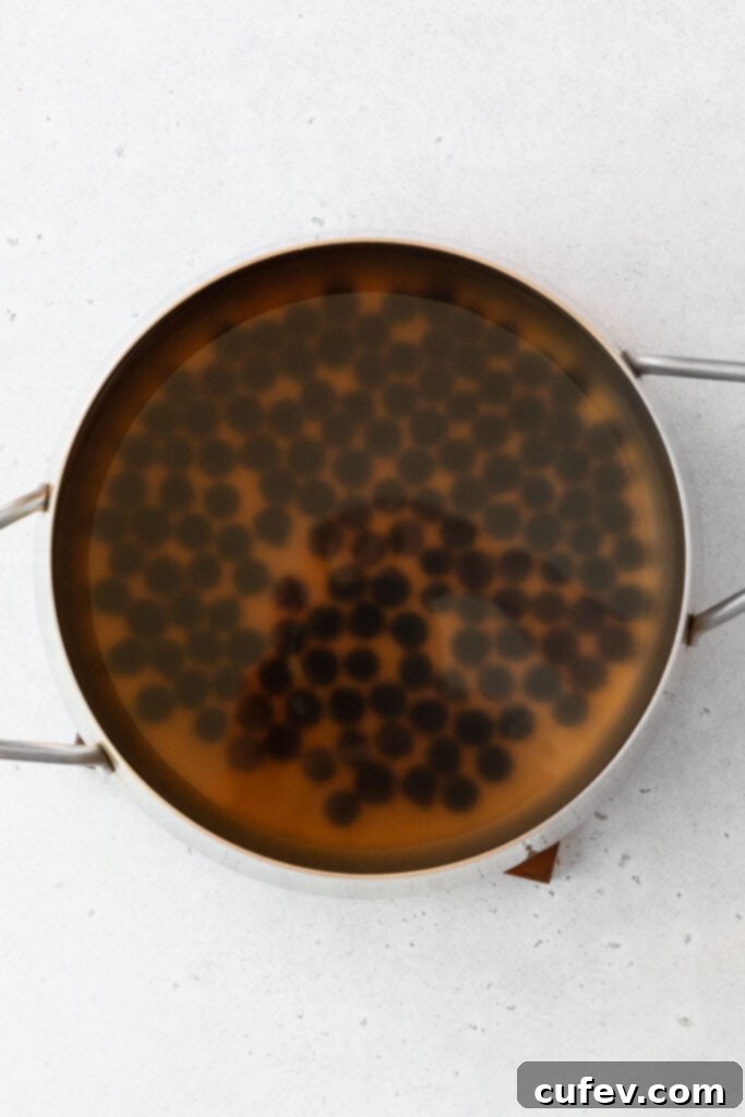 Tropical Mango Bubble Tea 5 Cooking boba pearls in a large pot on the stovetop, showing the pearls bubbling in water.