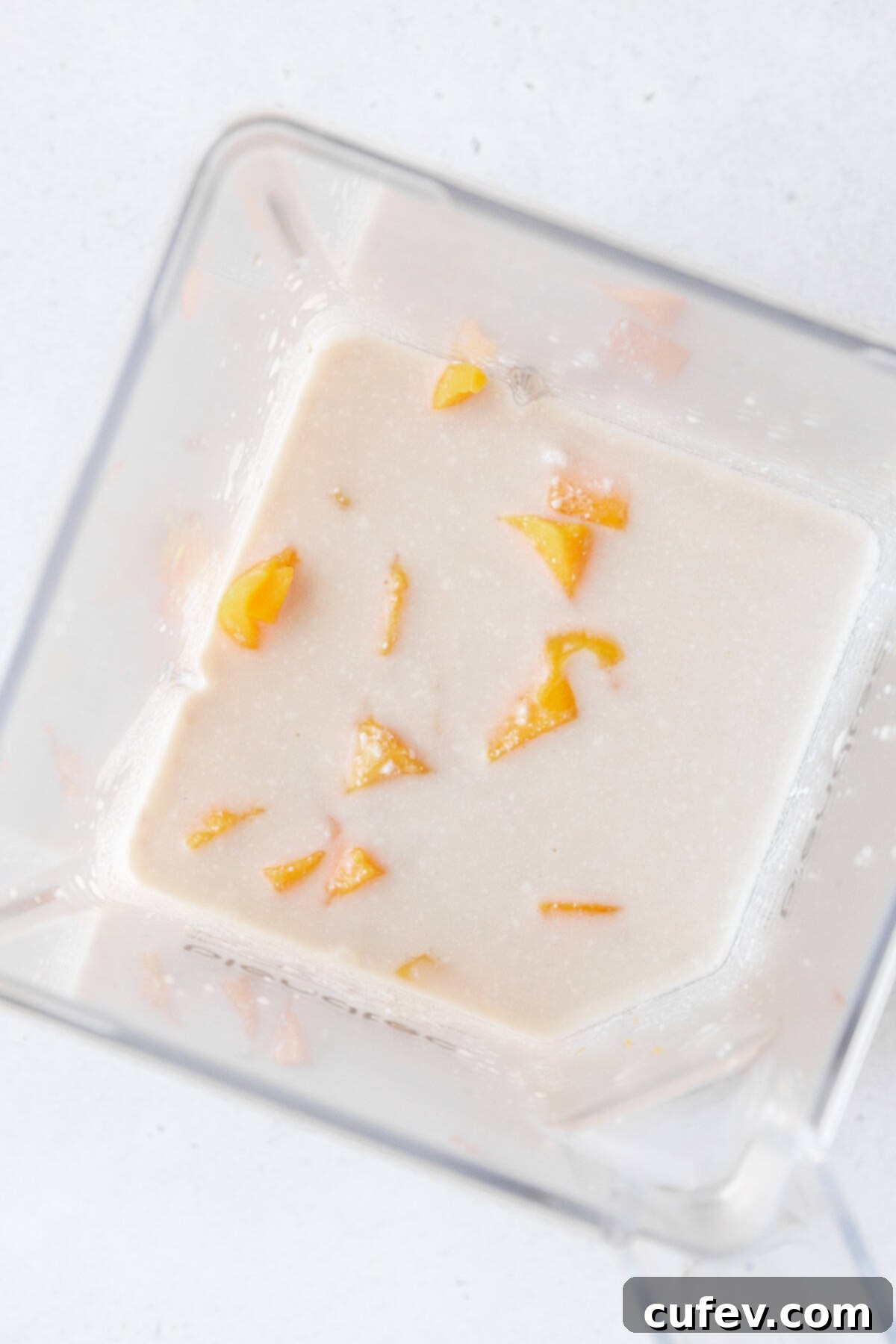 Tropical Mango Bubble Tea 9 Cubed mango, brewed jasmine tea, and coconut milk ready to be blended in a blender.