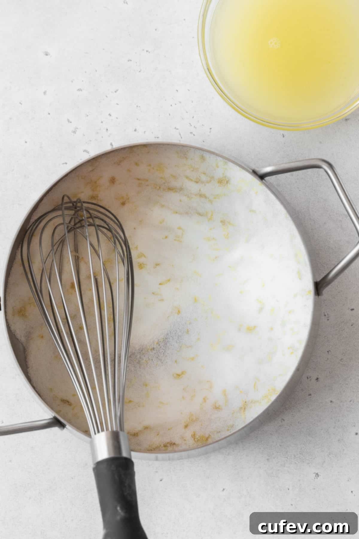 Lemon-infused sugar and cornstarch, whisked to perfection, sitting in a saucepan on the counter, ready for the next steps.
