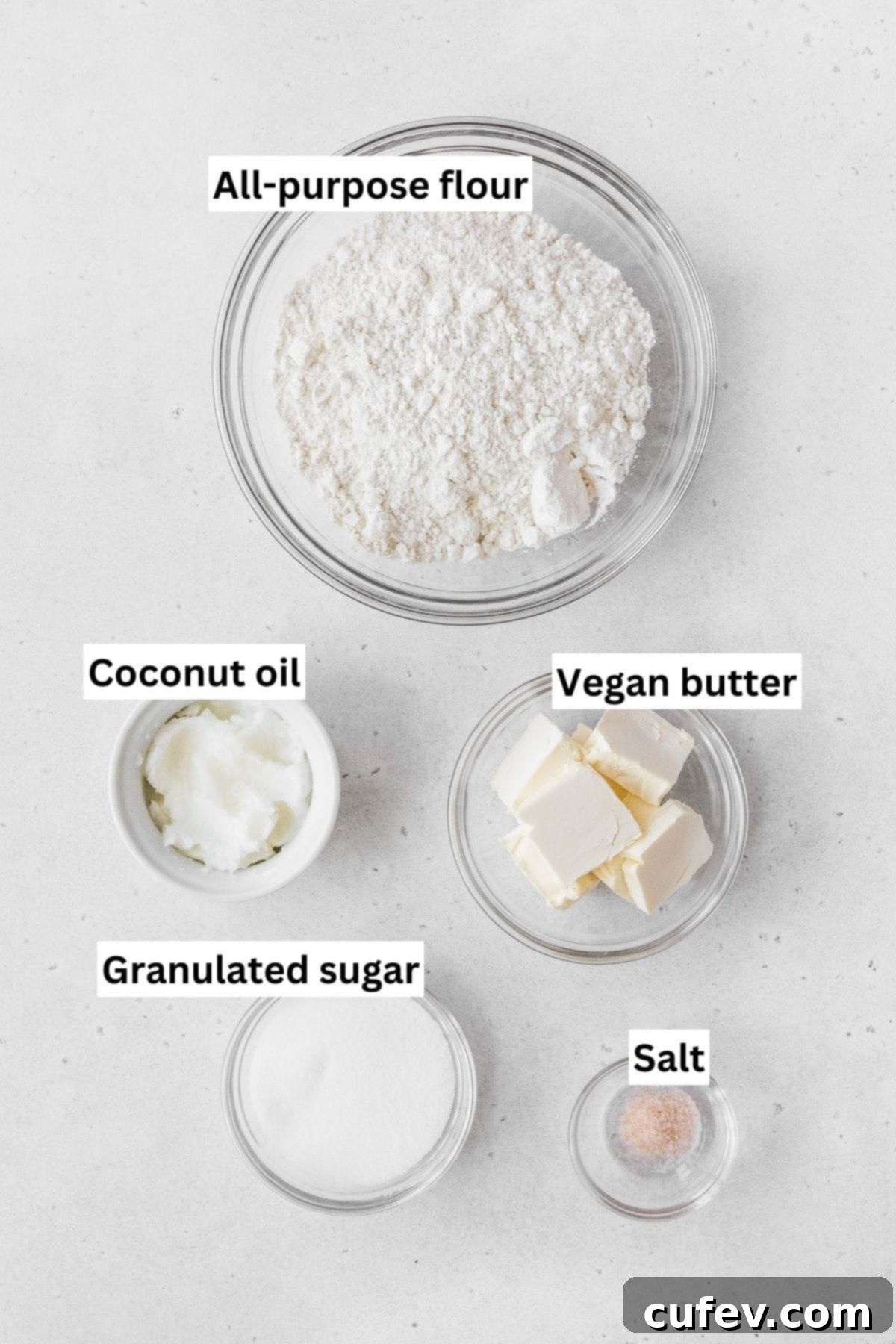 A collection of ingredients for the dairy-free shortbread crust, including flour, sugar, and vegan butter, neatly arranged on a kitchen counter.