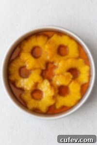Tropical Gluten-Free Pineapple Upside Down Dream 11 A cake pan of the brown sugar butter and pineapple rings in it.