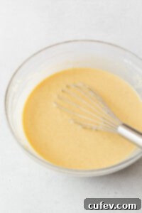 Tropical Gluten-Free Pineapple Upside Down Dream 10 A whisked bowl of the gluten-free pineapple cake batter with a whisk in it.