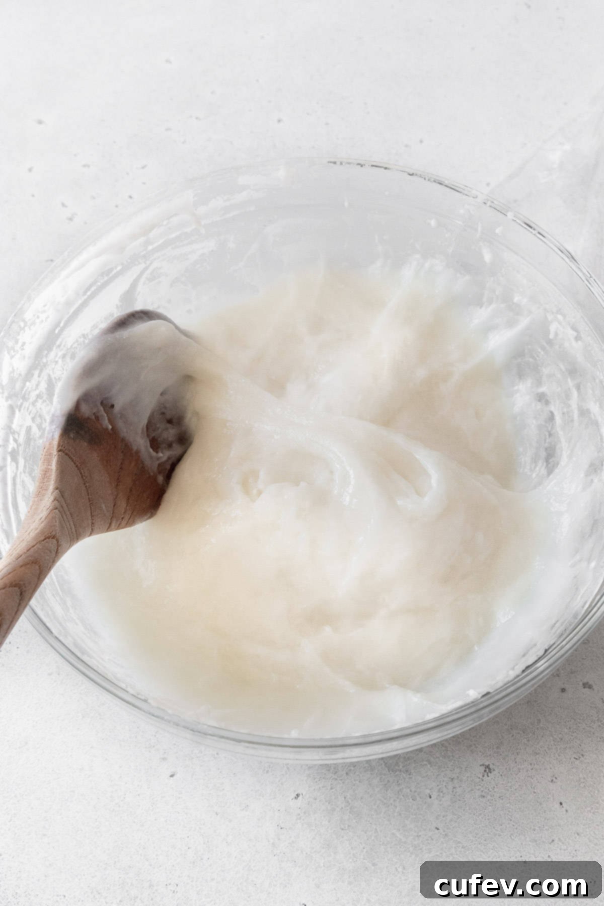 Fresh Japanese Strawberry Mochi 11 Daifuku mochi dough being mixed with a wooden spoon.