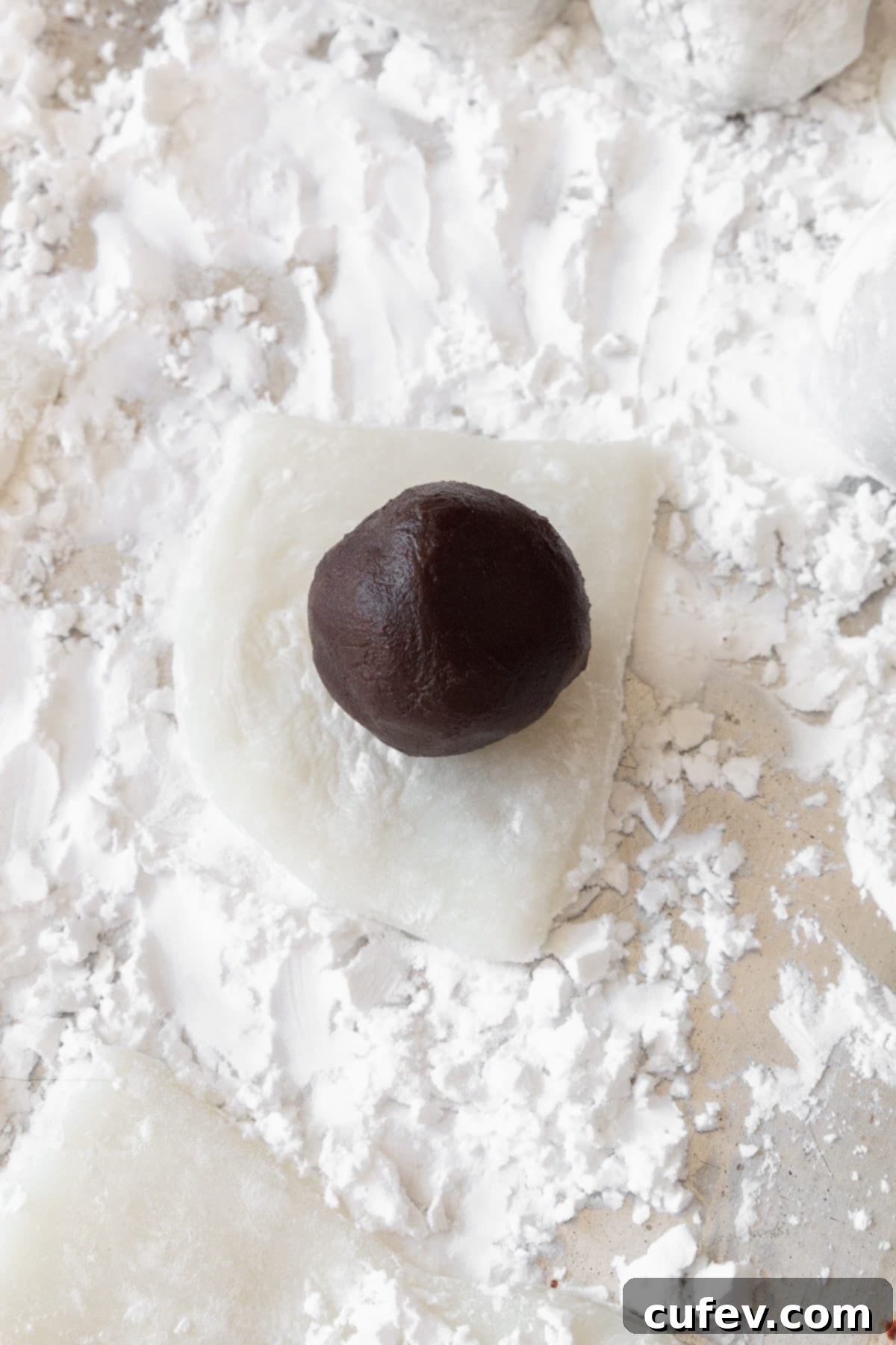 Fresh Japanese Strawberry Mochi 14 A ball of sweet red bean paste placed on a square of mochi to be wrapped in.