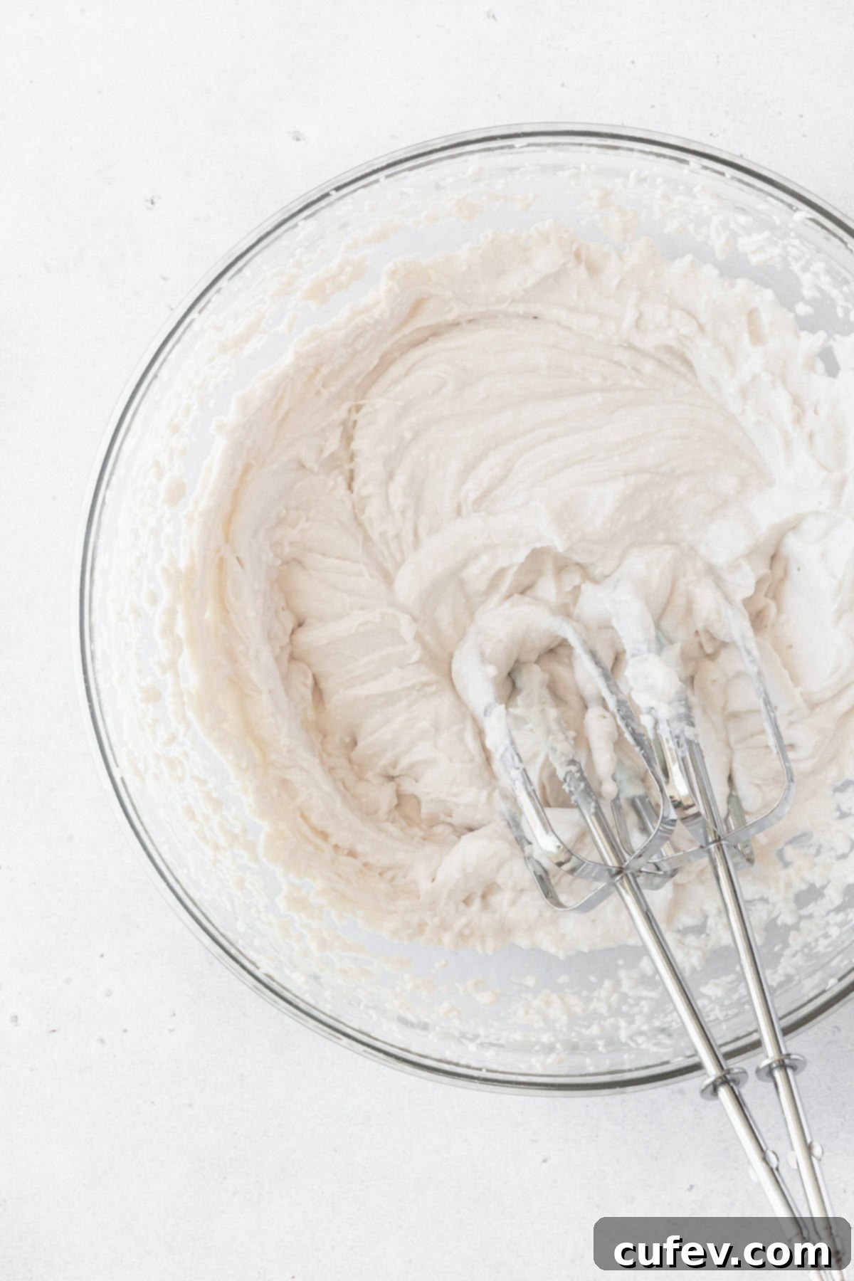 Fresh Japanese Strawberry Mochi 15 A bowl of vegan whipped cream with two beaters placed inside.