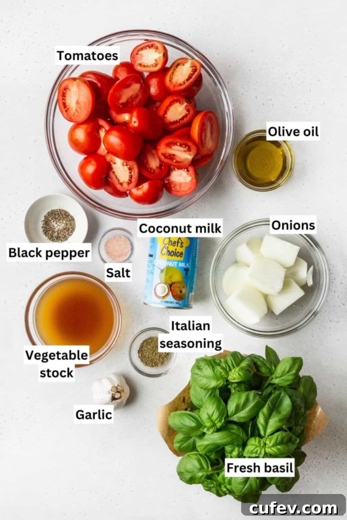 Ingredients for roasted tomato soup measured out into bowls with text overlay.